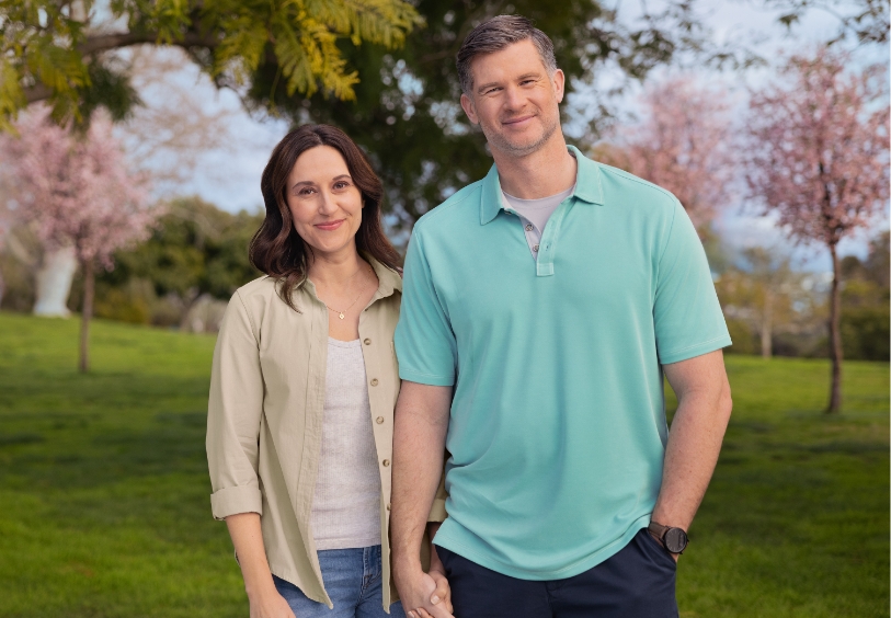 Actor portrayal of an HD patient and their caregiver smiling